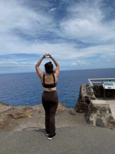 A woman practicing restorative breathing exercises, captured in warm morning sunlight to reduce stress and improve mental clarity.
