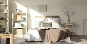 Minimalist bedroom with soft natural light and neatly layered bedding.
