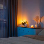 Sleep and the nervous system: calm bedroom with warm bedside lighting that supports a restorative nighttime routine.