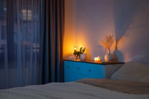 Sleep and the nervous system: calm bedroom with warm bedside lighting that supports a restorative nighttime routine.