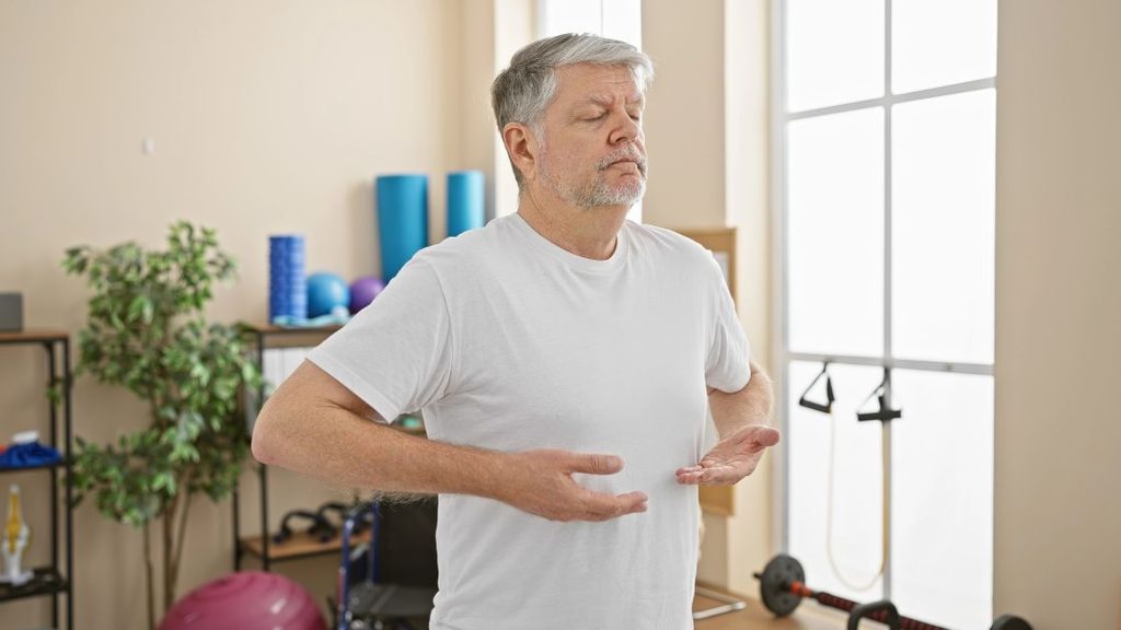 Person practicing slow breathing techniques to manage a panic attack during workout and reduce exercise-induced anxiety.